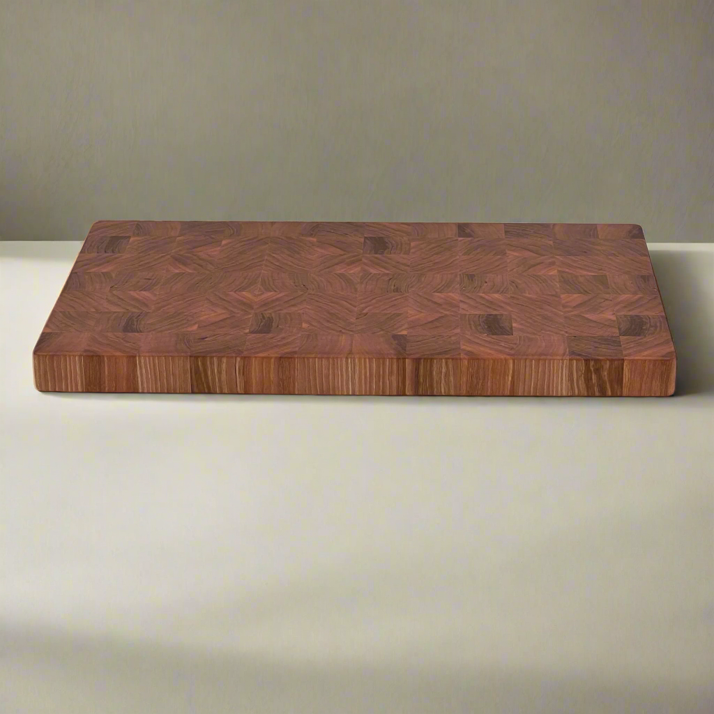 End grain chopping board in Cherry wood sitting on benchtop