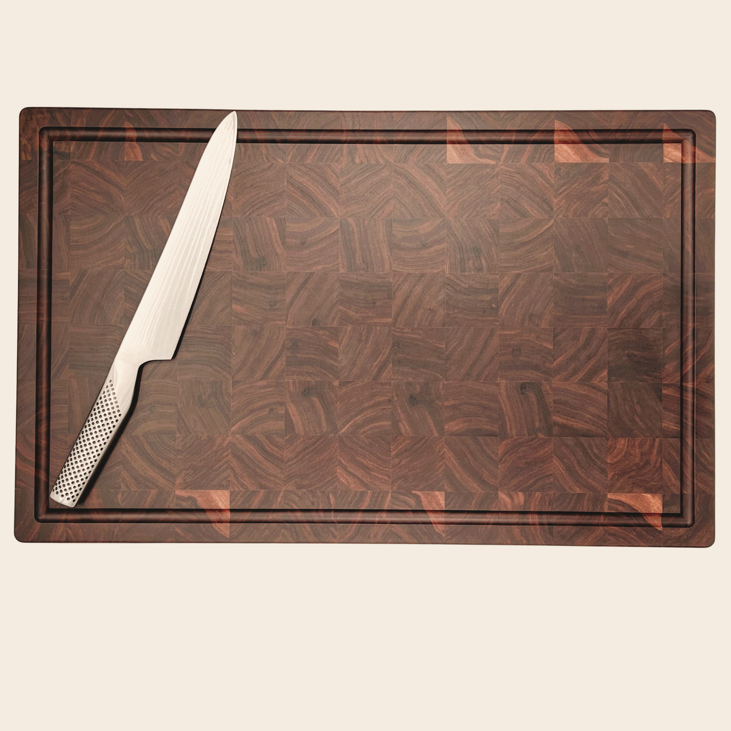 Pebble Studio Walnut chopping board with knife sitting on top
