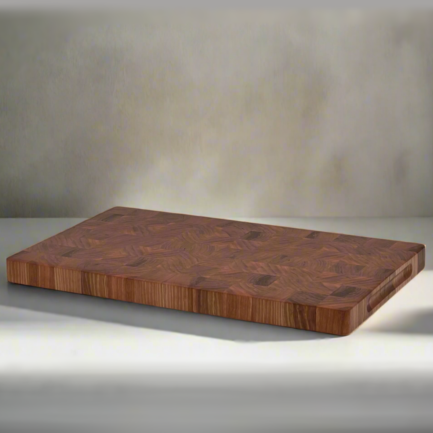 A handcrafted end-grain cherry wood chopping block with a rich, figured grain pattern, displayed on a grey background.