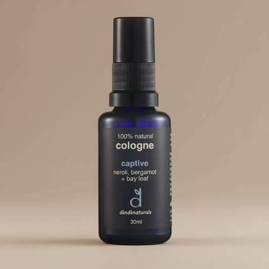 Black cologne bottle with text on a beige background