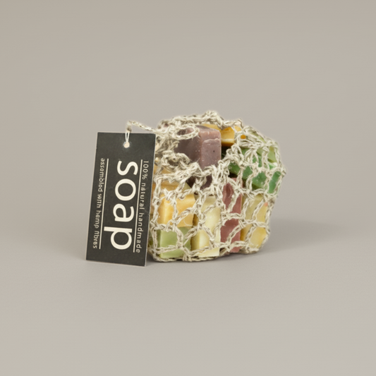 Colorful soap in a hemp bag with a 'soap' label on a beige background