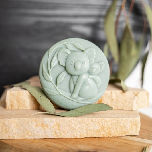 Green soap bar with a koala design on a stone block