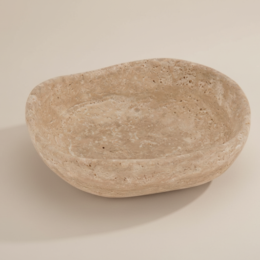 Beige stone bowl on a beige background
