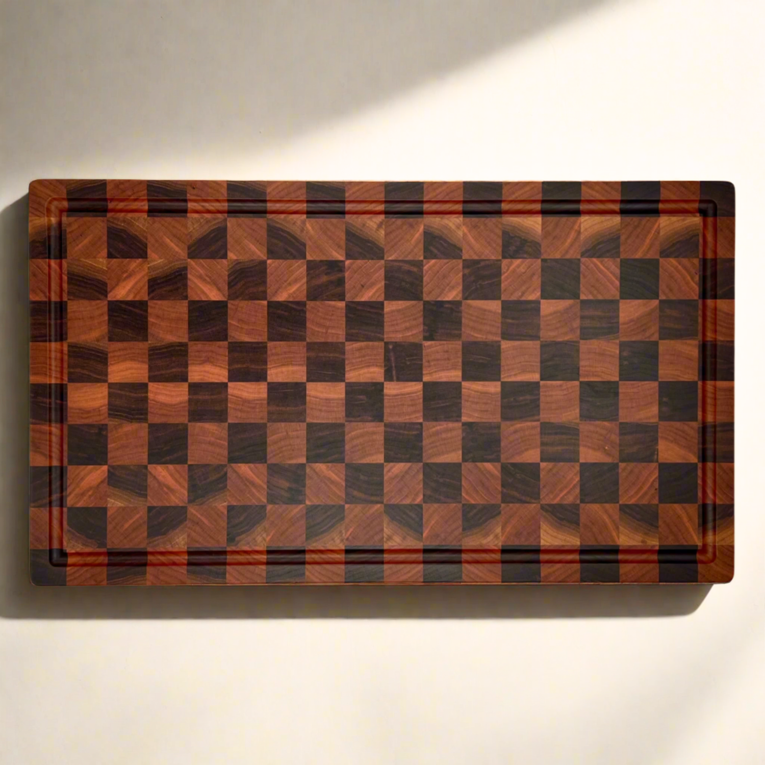 Wooden cutting board with a checkered pattern on a white background