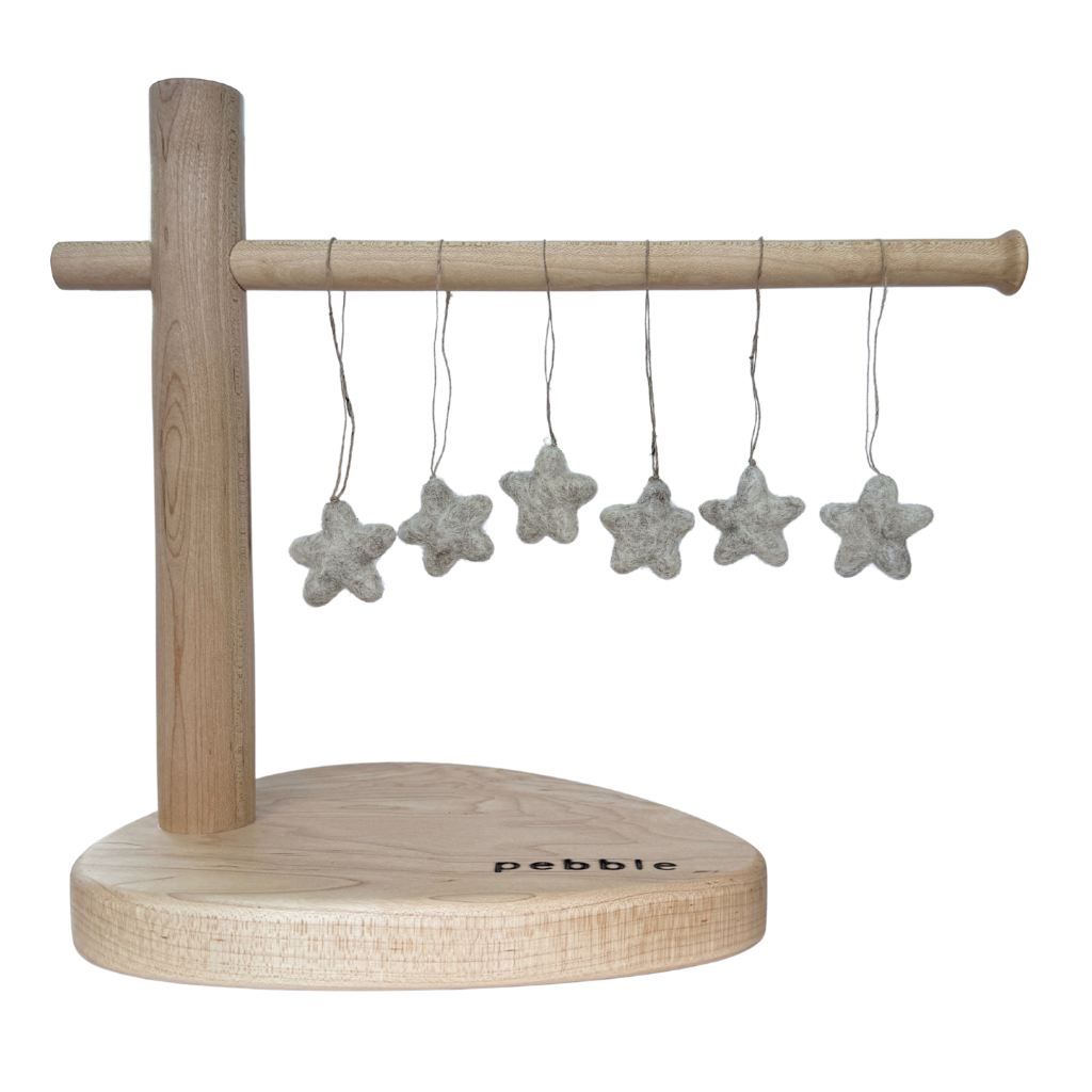 Six tiny felt star decorations hanging from a wooden stand
