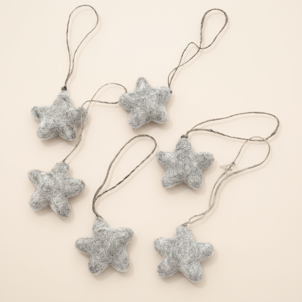 Star-shaped decorations with string on a beige background
