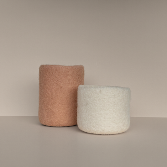 soft blush and snow handcrafted wool storage or vases on light background