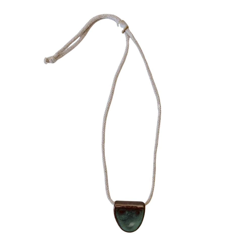 Necklace with a green ceramic pendant on a white background