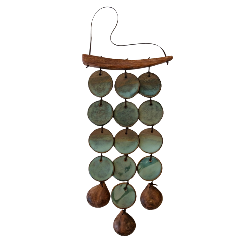 Decorative wind chime with ceramic and wood discs on a white background