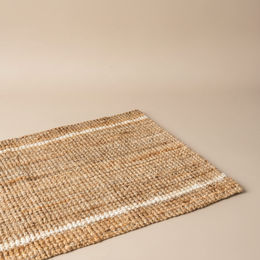Woven mat with striped pattern on a beige background