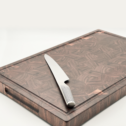 Walnut end grain chopping board with knife sitting on it