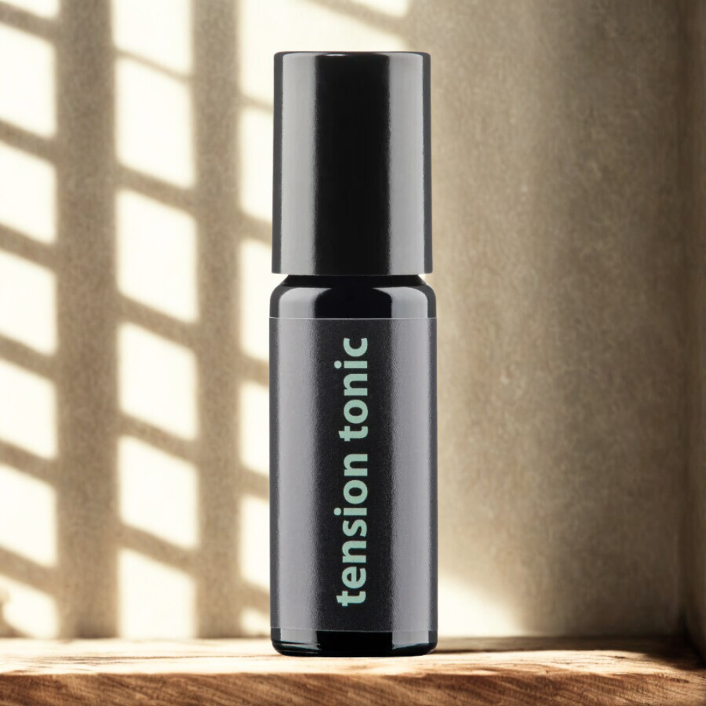 Bottle of 'tension tonic' on a wooden surface with a neutral background