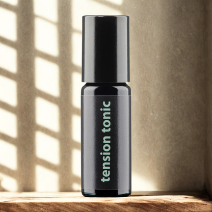 Bottle of 'tension tonic' on a wooden surface with a neutral background