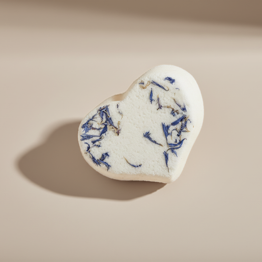 Heart-shaped bath bomb with lavender on a beige background
