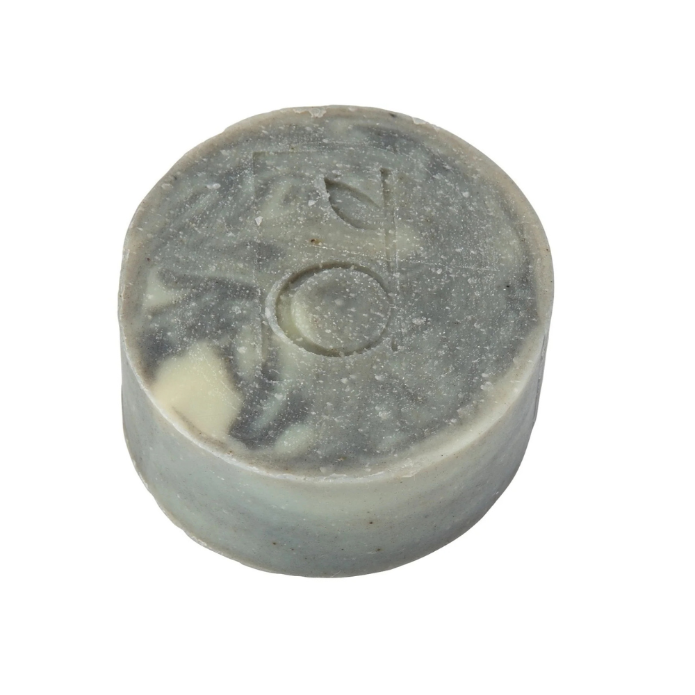 Round grey soap bar with branding on a white background