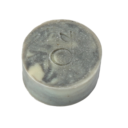 Round grey soap bar with branding on a white background