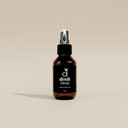 Bottle of dindi sleep natural body mist on a beige background