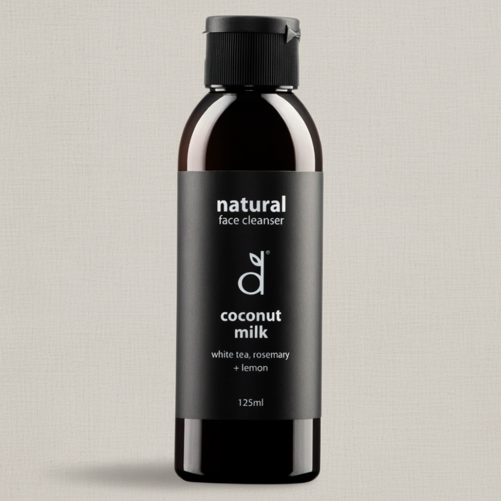 Bottle of Dindi Naturals natural face cleanser with coconut milk on a light grey background