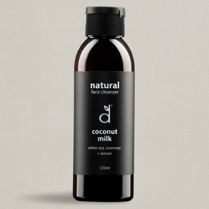 Bottle of Dindi Naturals natural face cleanser with coconut milk on a light grey background