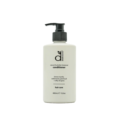 White bottle of conditioner with black pump on a white background