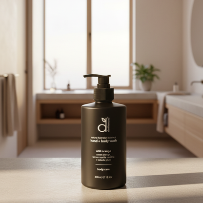Black bottle of hand and body wash on a bathroom counter with blurred background