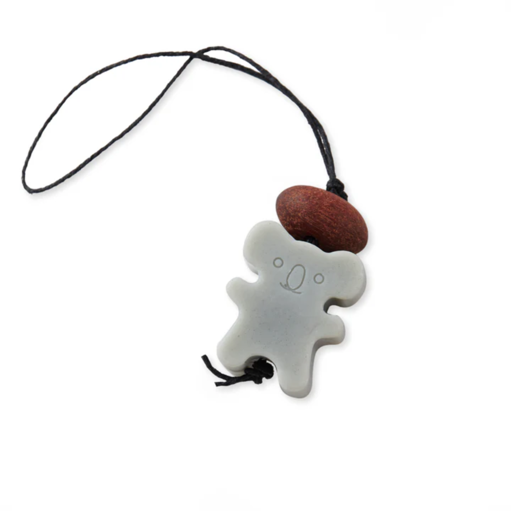 Wax koala air freshener with a brown on a black cord against a white background