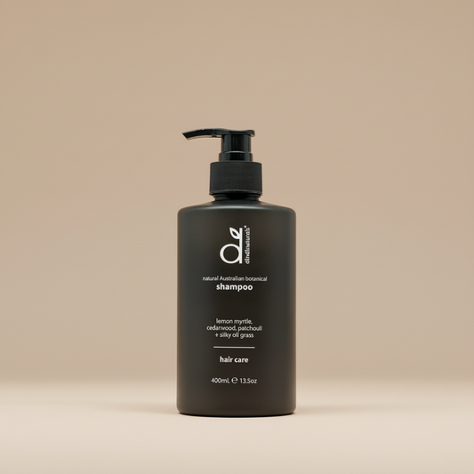 Black shampoo bottle on beige background