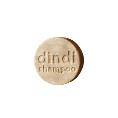 Dindi Naturals shampoo bar with 'dindi shampoo' text on a white background