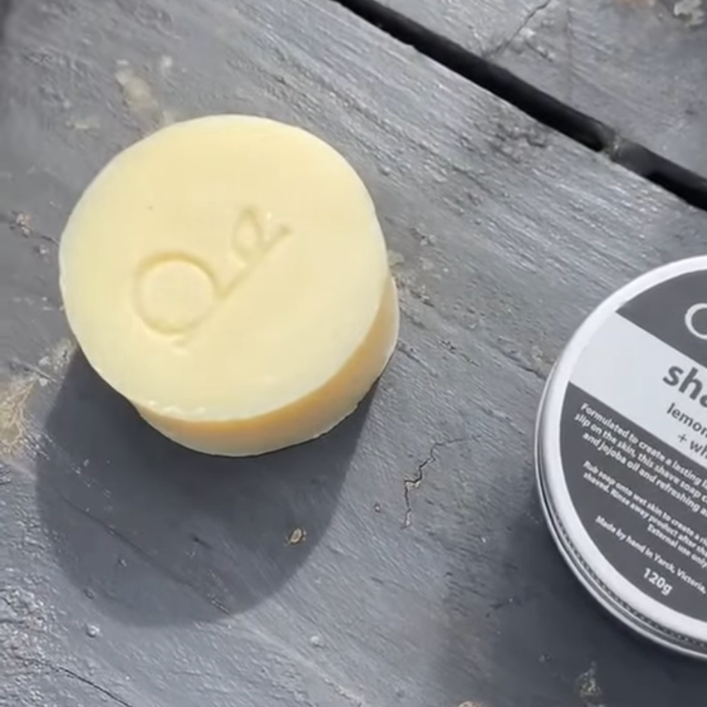 Bar of soap with a brand logo on a wooden surface