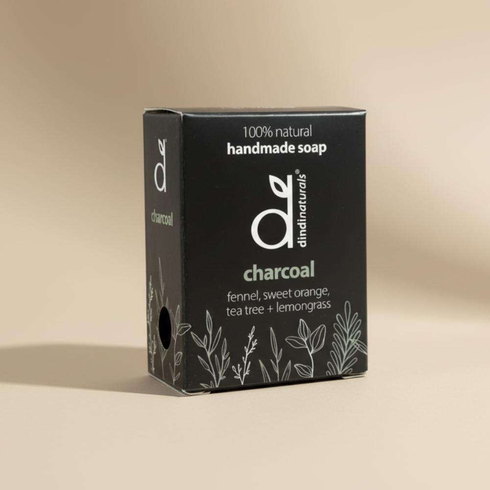 Box of Dindi Natural's charcoal soap on a beige background