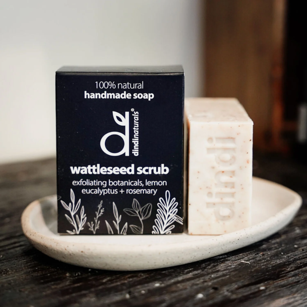 Handmade soap bar with packaging on a wooden surface