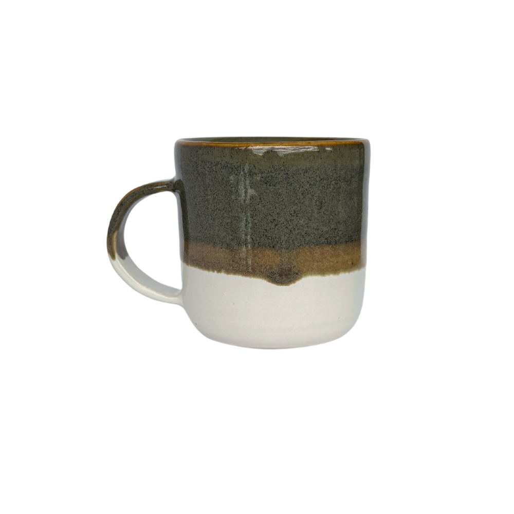 Handmade ceramic mug by artisan Eli C. featuring an earthy green, ochre, and white glaze, displayed on a light backdrop with natural lighting.