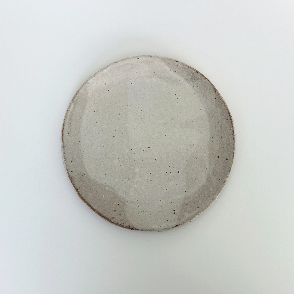 Round round ceramic plate on a white background