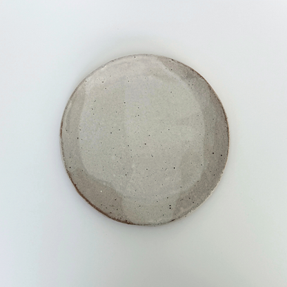 Round round ceramic plate on a white background