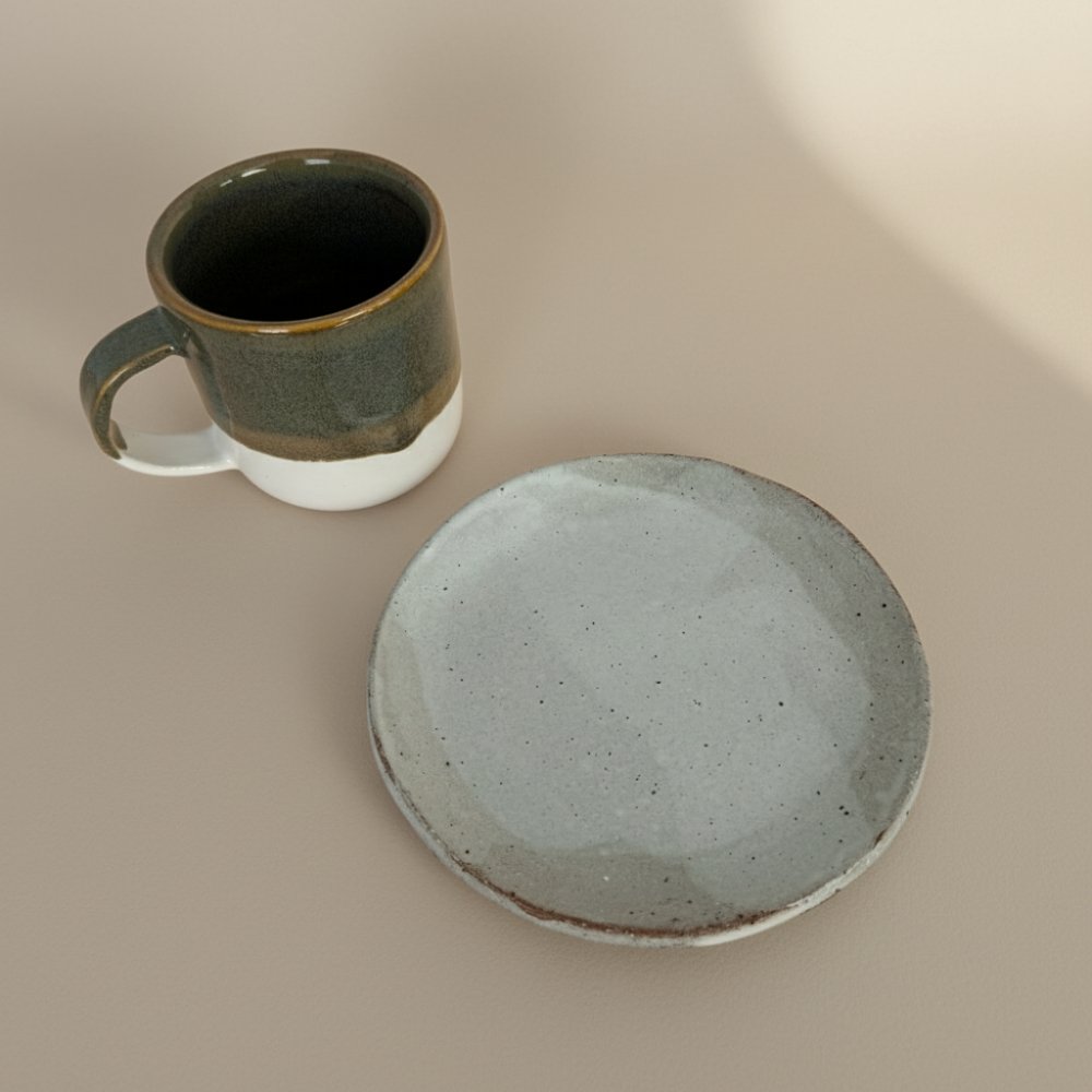 Ceramic mug and plate on a beige background