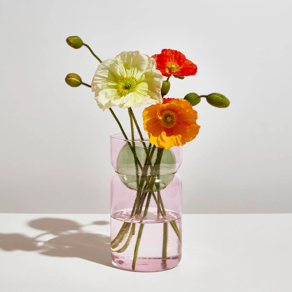 Fazeek pink glass vase with green sphere insert, holding flowers on a white background