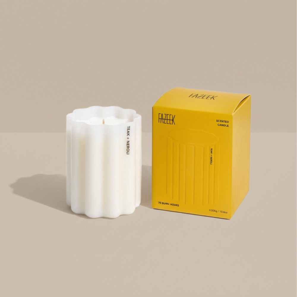 Fazeek Wave Candle with Teak and Neroli Scent next to a yellow box on a beige background