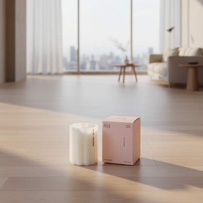 Fazeek Wave Candle with Vetiver and Pink Pepper scent sitting next to a pink canlde box in a living room