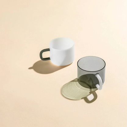Two mugs on a beige background