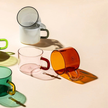 Colourful glass mugs on a light background