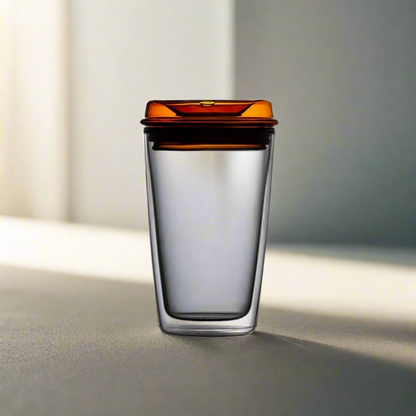 Grey glass cup with orange lid. Can be used for tea, coffee or other beverages