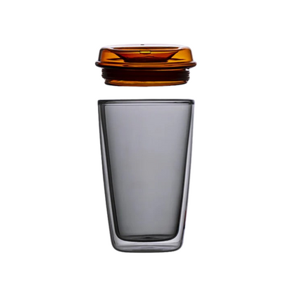 Grey glass cup with orange lid. Can be used for tea, coffee or other beverages