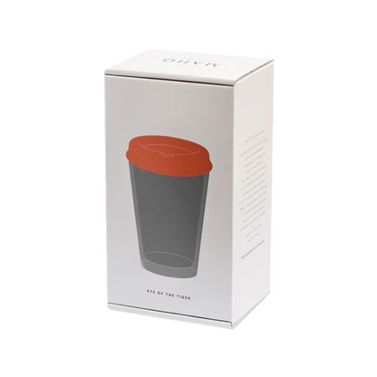 Grey glass cup with orange lid in a box. Can be used for tea, coffee or other beverages