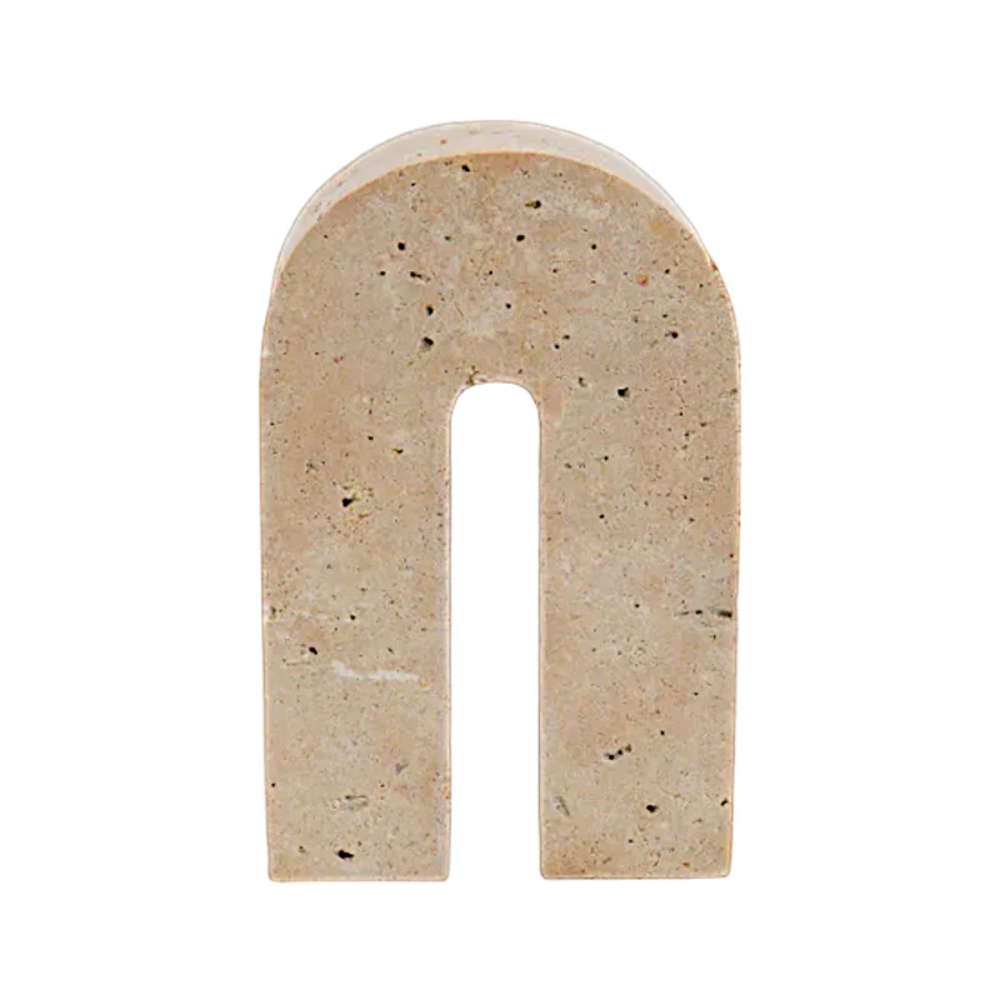 Beige arch-shaped travertine sculpture on a white background