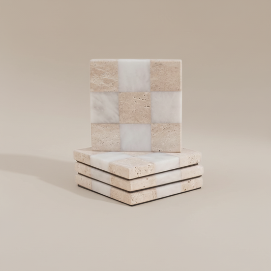 Stack of square stone coasters with a checkered pattern on a beige background