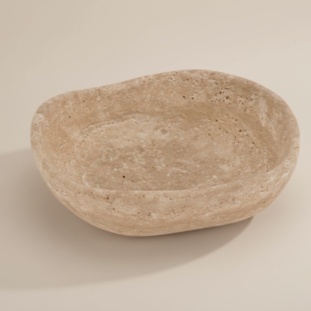 Beige stone bowl on a beige background