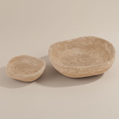 Two stone bowls on a beige background