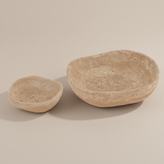Two stone bowls on a beige background