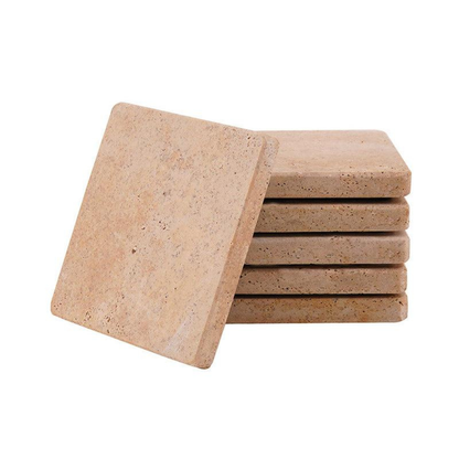 Set of square travertine stone coasters on a white background