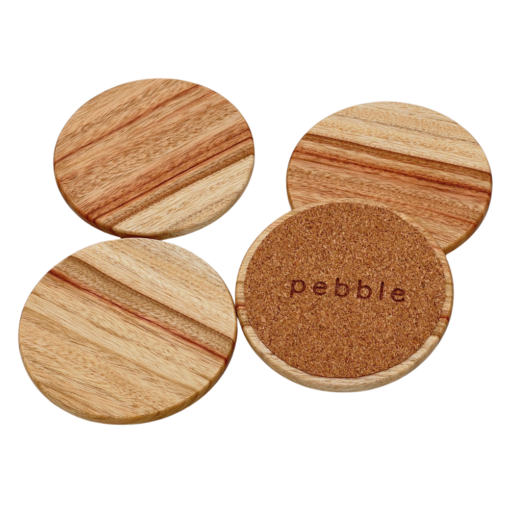 Four wooden coasters with cork bottom on a white background, branded 'Pebble'.